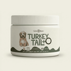 A white plastic jar of Canine Bloom Turkey Tail+ dog supplement, featuring a label with a small dog photo and dark green text, set against a solid light beige background.